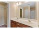 Bathroom featuring a double sink vanity, mirror, and vanity lighting at 2306 Stoney Spring Dr, Raleigh, NC 27610