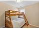 Bedroom with wooden bunk beds and a window that lets in lots of natural light at 2306 Stoney Spring Dr, Raleigh, NC 27610