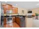 Well-equipped kitchen featuring stainless steel appliances, dark granite countertops, and a breakfast bar for a modern look at 2306 Stoney Spring Dr, Raleigh, NC 27610