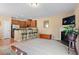 Spacious living area with a fireplace, bar seating, and a seamless transition to the kitchen, ideal for modern living at 2306 Stoney Spring Dr, Raleigh, NC 27610