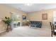 Bright living room featuring neutral carpet, sliding doors, and a cozy seating area with plenty of natural light at 2306 Stoney Spring Dr, Raleigh, NC 27610