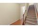 Inviting staircase with carpeted steps and a classic wooden banister, leading to the upper level of the home at 2306 Stoney Spring Dr, Raleigh, NC 27610