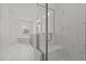 Luxurious bathroom with marble tile, glass shower, and soaking tub at 2613 Coxindale Dr, Raleigh, NC 27615