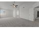 Large bedroom with neutral carpet, ceiling fan, and ensuite bathroom access at 2613 Coxindale Dr, Raleigh, NC 27615