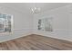 Bright dining room features hardwood floors, neutral-colored walls, and a chandelier at 2613 Coxindale Dr, Raleigh, NC 27615