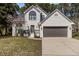 Charming, two-story brick home boasting a beautiful yard and a two-car garage at 2613 Coxindale Dr, Raleigh, NC 27615