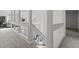 Second-floor hallway with glass paneled railing and stairs leading to the first floor at 2613 Coxindale Dr, Raleigh, NC 27615