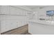 Bright kitchen features white cabinets, subway tile backsplash, and wood-look flooring at 2613 Coxindale Dr, Raleigh, NC 27615