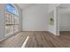 Living room with hardwood floors, high ceilings, and a large window providing plenty of light at 2613 Coxindale Dr, Raleigh, NC 27615