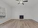 Bright living room features hardwood floors, a fireplace, and a ceiling fan at 2613 Coxindale Dr, Raleigh, NC 27615