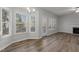 Bright living room with wood floors, large windows, and a fireplace at 2613 Coxindale Dr, Raleigh, NC 27615