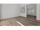 Living room with hardwood floors and large windows, adjacent to dining area at 2613 Coxindale Dr, Raleigh, NC 27615