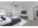 Staged main bedroom with accent wall, soft rug, ceiling fan, and ensuite bathroom at 2613 Coxindale Dr, Raleigh, NC 27615