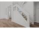 Carpeted staircase featuring glass panels and wood trim, leading to upper level at 2613 Coxindale Dr, Raleigh, NC 27615