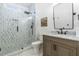 This bathroom features a tiled shower with modern fixtures, a toilet, and a vanity with a marble countertop at 2720 Stratford Hall Dr, Raleigh, NC 27614