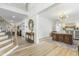 Bright foyer boasts soaring ceilings, wood floors, striking chandelier and staircase with decorative woodwork at 2720 Stratford Hall Dr, Raleigh, NC 27614