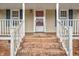 Close-up of the home's front porch highlighting brick stairs and white railing, creating a warm welcome at 2785 Green Rd, Spring Hope, NC 27882