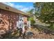 Quaint brick house with a welcoming front porch featuring classic white railings at 2911 Broad St, Durham, NC 27704