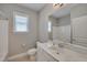 Bright bathroom features a single sink vanity with storage and a shower/tub combo at 300 Mariah Towns Way, Garner, NC 27529