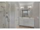 Bright bathroom features a glass door shower, double sink vanity with white cabinetry, and tile flooring at 300 Mariah Towns Way, Garner, NC 27529