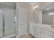 Bright bathroom features a glass door shower, double sink vanity with white cabinetry, and tile flooring at 300 Mariah Towns Way, Garner, NC 27529