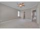 Spacious bedroom features neutral walls and carpet, a ceiling fan, and an ensuite bathroom entrance at 300 Mariah Towns Way, Garner, NC 27529