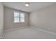 Neutral bedroom with a large window providing natural light and neutral carpet and walls at 300 Mariah Towns Way, Garner, NC 27529