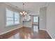 Dining room area showcasing modern lighting fixtures, hardwood flooring, and a breakfast bar at 300 Mariah Towns Way, Garner, NC 27529