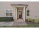 Covered front porch, front door with sidelight windows, and well maintained landscaping at 300 Mariah Towns Way, Garner, NC 27529