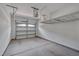 Spacious garage with concrete floors, overhead storage rack, and automated garage door at 300 Mariah Towns Way, Garner, NC 27529