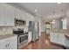 Bright kitchen boasts stainless appliances, granite countertops, and white cabinets at 300 Mariah Towns Way, Garner, NC 27529