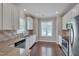 Kitchen area features granite countertops, stainless steel appliances, and updated lighting at 300 Mariah Towns Way, Garner, NC 27529