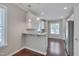 Eat in Kitchen featuring white cabinetry, granite countertops, and stainless steel appliances at 300 Mariah Towns Way, Garner, NC 27529