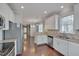 Bright kitchen features stainless appliances, granite countertops, and hardwood floors at 300 Mariah Towns Way, Garner, NC 27529