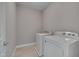 Convenient laundry room with tile floors and white washer and dryer at 300 Mariah Towns Way, Garner, NC 27529