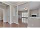 Open-concept living room with hardwood floors, fireplace, and natural light at 300 Mariah Towns Way, Garner, NC 27529