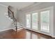 Hardwood floors with staircase and French doors to backyard at 300 Mariah Towns Way, Garner, NC 27529