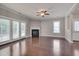 Bright living room offers hardwood floors, a fireplace, and large windows at 300 Mariah Towns Way, Garner, NC 27529