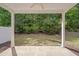 Covered patio offers outdoor living space with ceiling fan and peaceful views of the backyard at 300 Mariah Towns Way, Garner, NC 27529