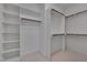Walk-in closet with multiple shelves and hanging rods for ample storage and organization at 300 Mariah Towns Way, Garner, NC 27529