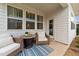 Covered back porch with wicker furniture and a table at 308 Masden Rd, Holly Springs, NC 27540
