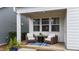 Inviting back porch with seating and an outdoor table and rug at 308 Masden Rd, Holly Springs, NC 27540