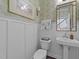 Elegant powder room featuring charming wallpaper, framed art, and pedestal sink at 308 Masden Rd, Holly Springs, NC 27540