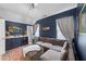 Comfortable bonus room with a large sectional sofa and beverage cooler at 308 Masden Rd, Holly Springs, NC 27540