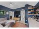 Cozy bonus room with blue walls, shelving, and an entrance into an adjoining bathroom at 308 Masden Rd, Holly Springs, NC 27540