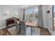 Dining room with natural wood table, patterned chairs, a buffet, and large windows at 308 Masden Rd, Holly Springs, NC 27540