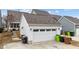 A two-car garage featuring a white door and several windows along the top section at 308 Masden Rd, Holly Springs, NC 27540