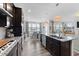 Modern kitchen with granite countertops, stainless steel appliances, and open layout to the living room at 308 Masden Rd, Holly Springs, NC 27540