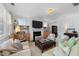 Bright and airy living room featuring a fireplace, built-in shelves, and comfortable seating arrangements at 308 Masden Rd, Holly Springs, NC 27540