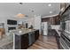 Open floorplan with seamless transition from the kitchen with island to the cozy living room with fireplace at 308 Masden Rd, Holly Springs, NC 27540